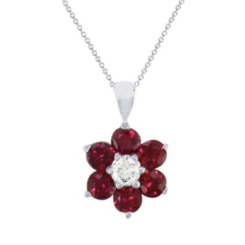 18ct white gold ruby and diamond flower shaped pendant and chain.