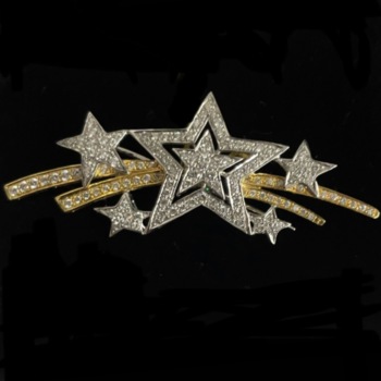 Yellow and white gold shooting star brooch.